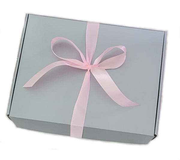 Gray gift box with a pink ribbon on a white background